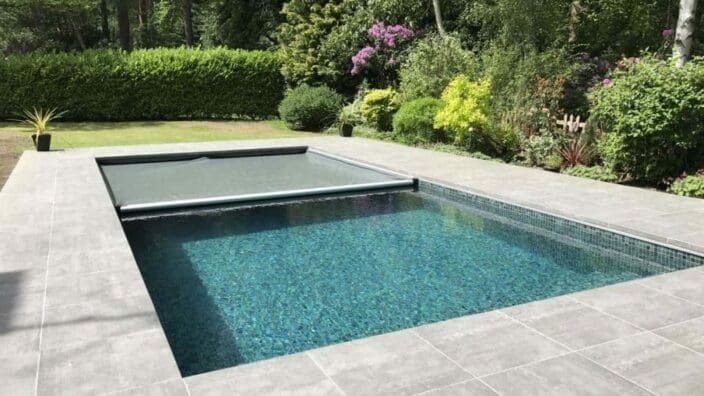 Rectangular pool with gray roller cover